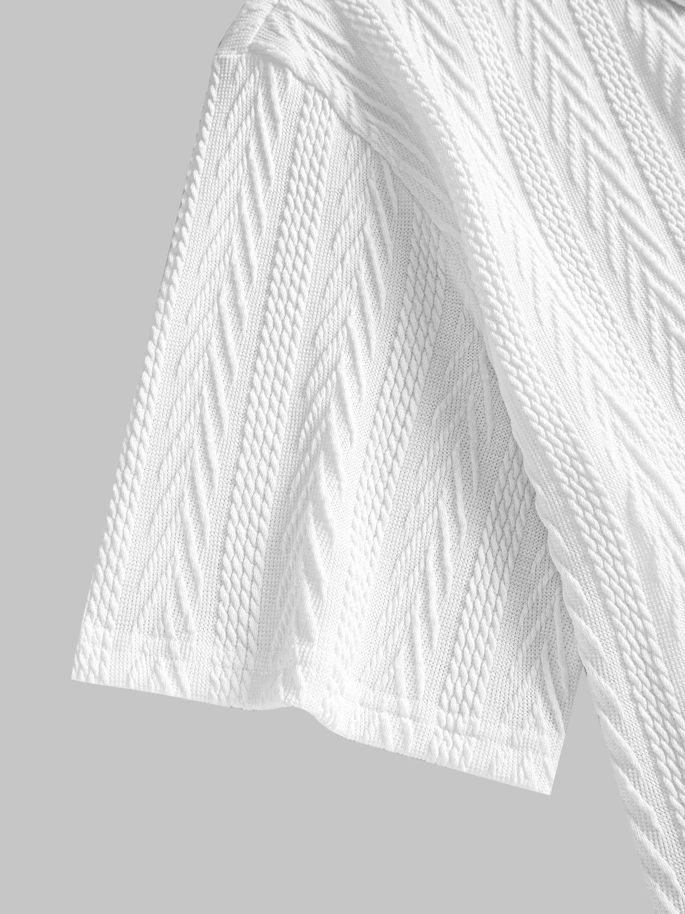 White knit polo shirt with chevron texture, short rolled sleeves and structured collar — understated silhouette for clean summer dressing.