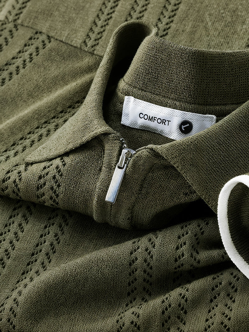 Dark green knit polo shirt with front zipper and structured collar — breathable lightweight design with quiet authority.