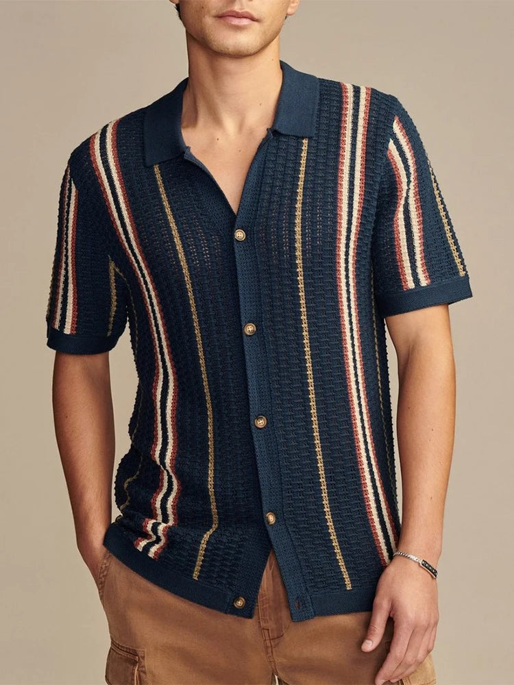Dark blue striped knit shirt with turn-down collar and soft drape — casual structure with understated refinement for warm seasons.
