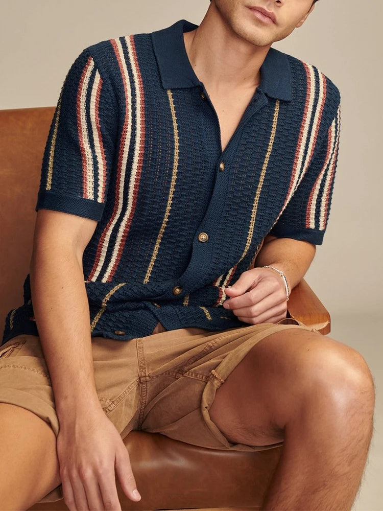 Dark blue striped knit shirt with turn-down collar and soft drape — casual structure with understated refinement for warm seasons.