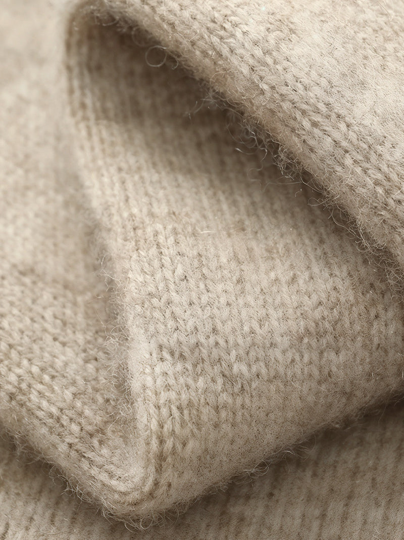 Natural beige merino wool sweater with central zipper, ribbed neckline and soft knit texture — refined layers for colder days with timeless elegance.