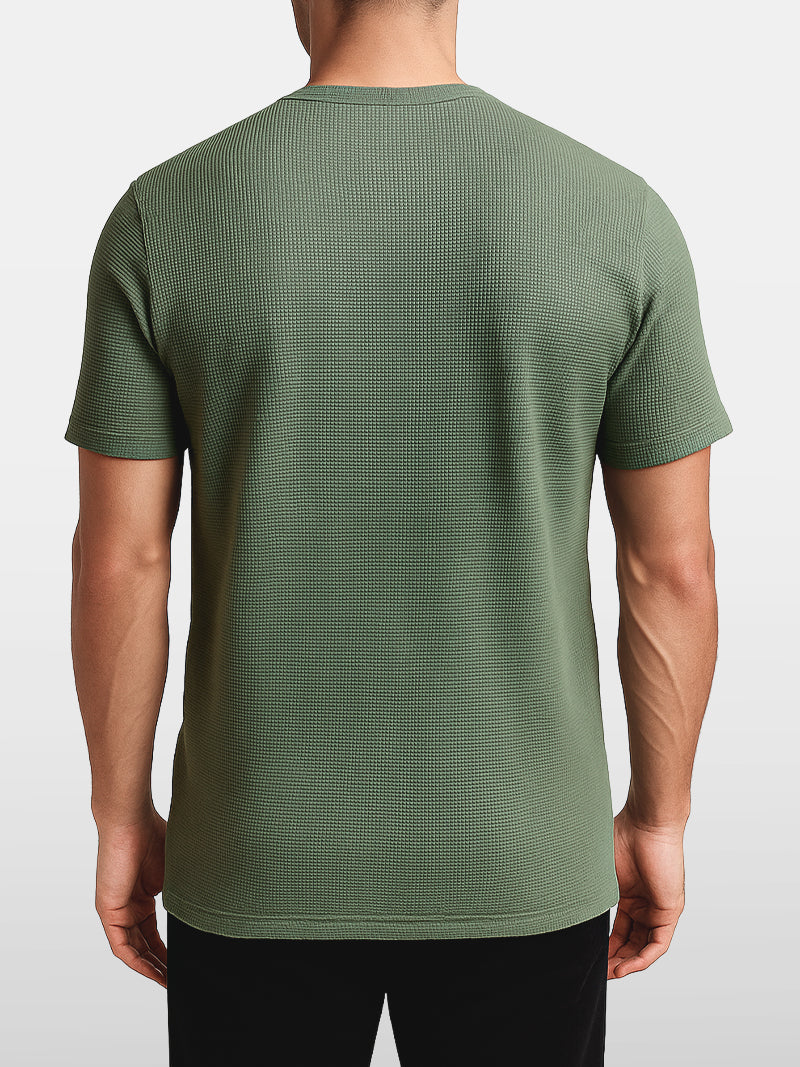 Green knit t-shirt with minimalist O-neck and soft stretch weave — lightweight and breathable design for refined simplicity.