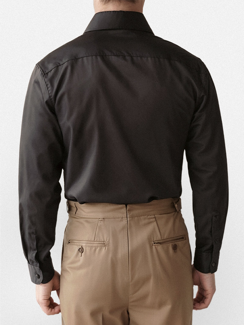 Black casual shirt with structured collar and smooth broadcloth finish — versatile staple with discreet presence.