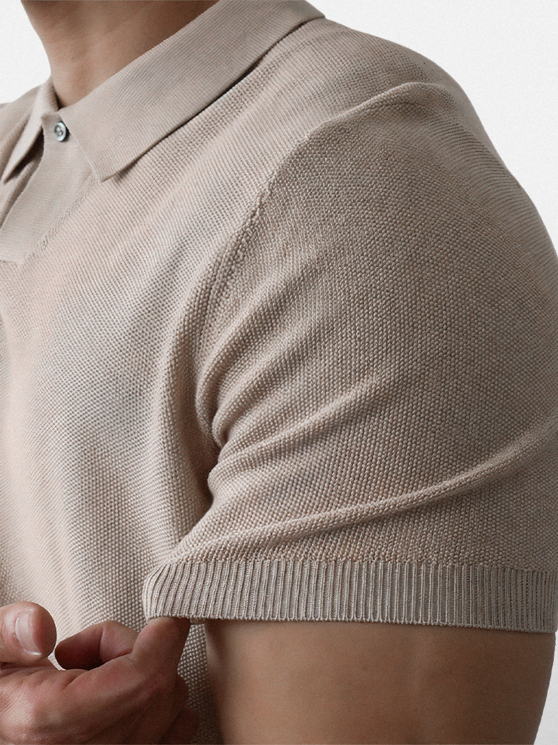 Apricot short sleeve polo with ribbed cuffs and compact knit — warm neutral tone with elegant fit.
