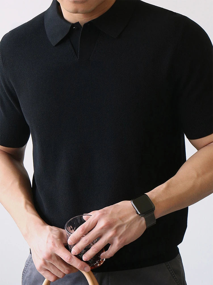 Black knit polo shirt with clean structure and subtle stretch — compact fabric and silent silhouette.