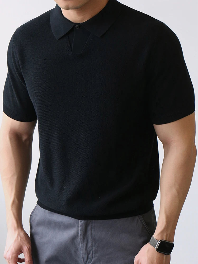 Black knit polo shirt with clean structure and subtle stretch — compact fabric and silent silhouette.