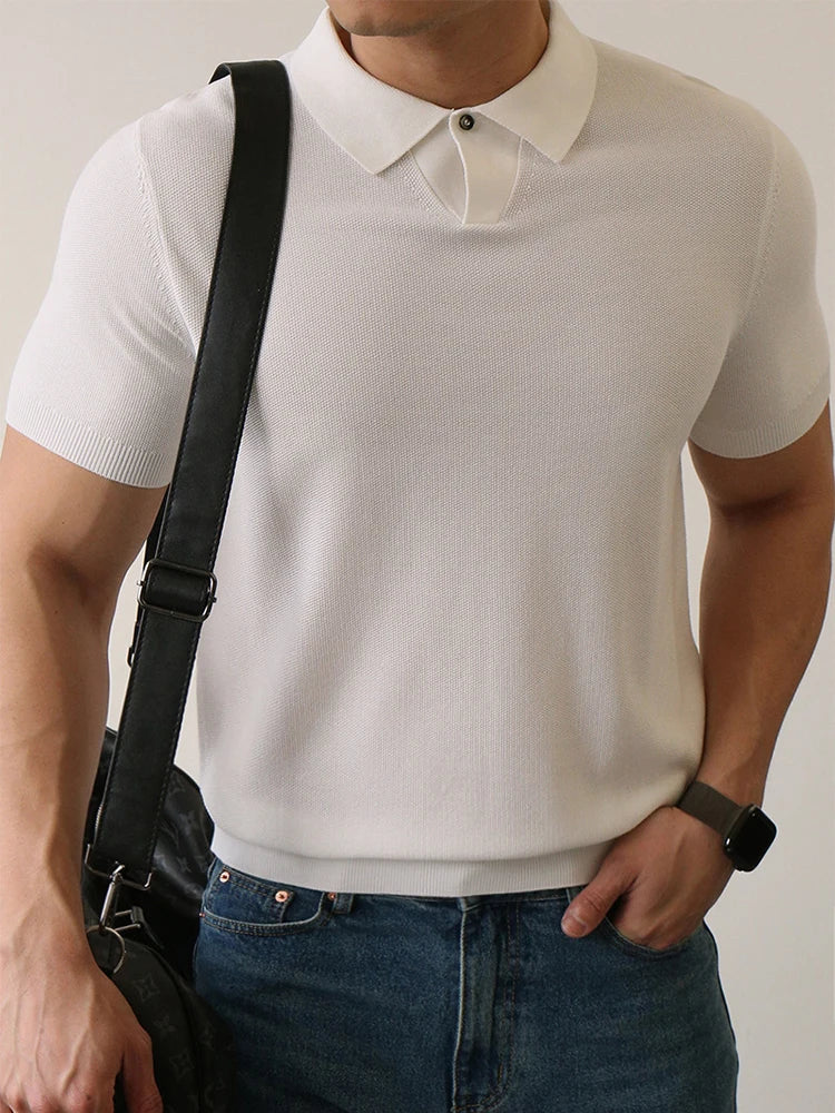 White slim-fit polo shirt with ribbed sleeves and compact knit — lightweight structure with silent presence.