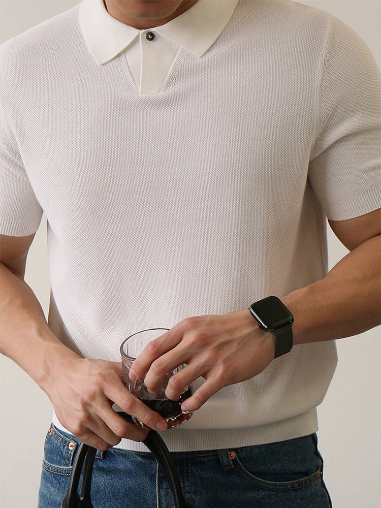 White slim-fit polo shirt with ribbed sleeves and compact knit — lightweight structure with silent presence.