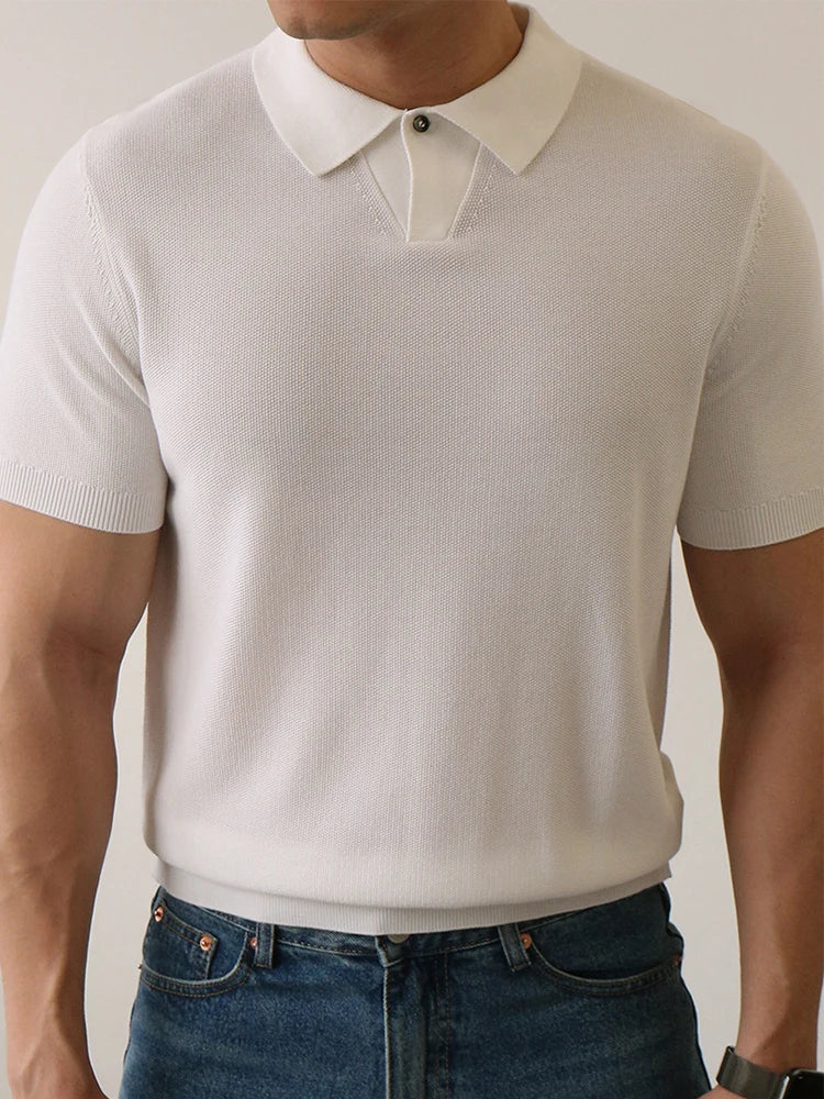 White slim-fit polo shirt with ribbed sleeves and compact knit — lightweight structure with silent presence.