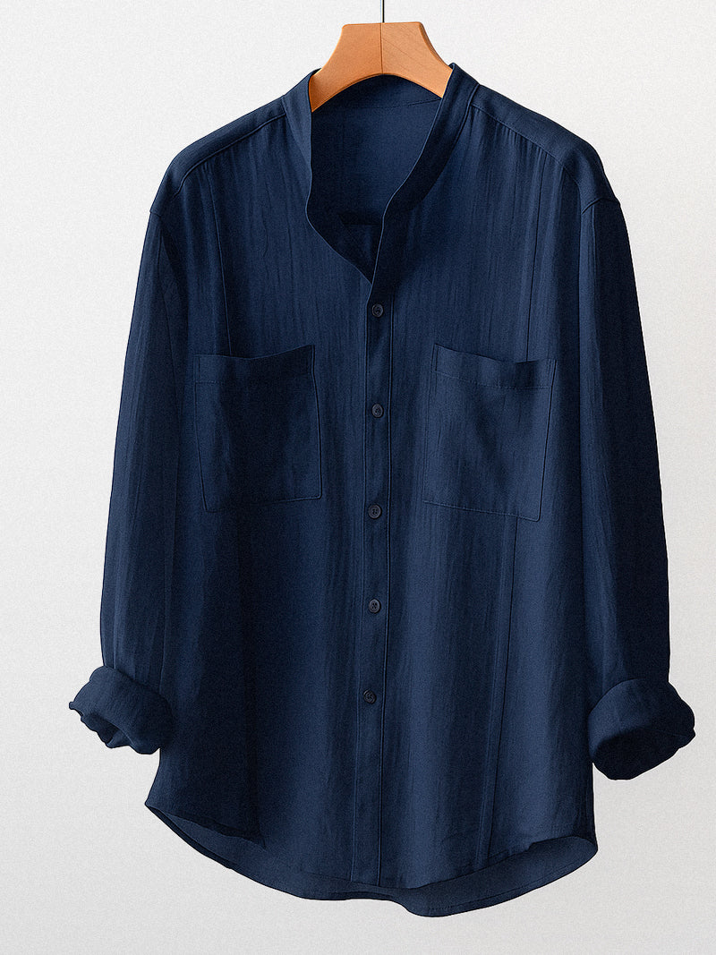 Navy linen shirt with a modern band collar, front double pockets and relaxed silhouette — refined texture and silent elegance for everyday presence.