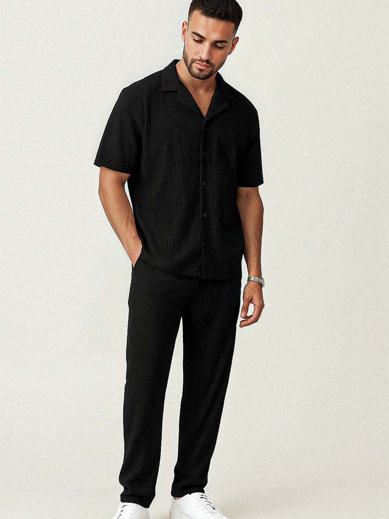Black striped two-piece set for men with breathable short sleeve shirt and relaxed pants — discreet elegance in a structured silhouette.