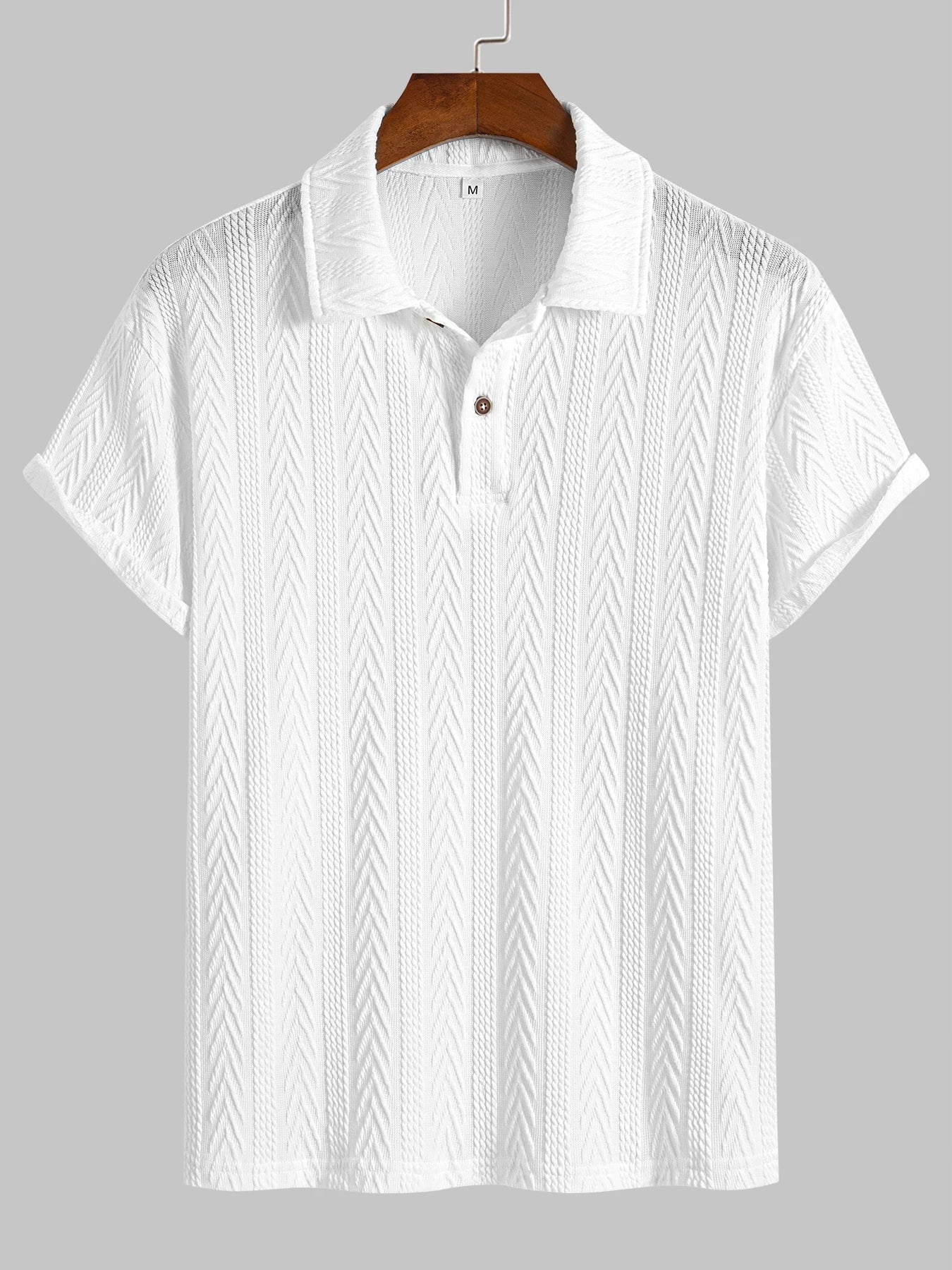 White knit polo shirt with chevron texture, short rolled sleeves and structured collar — understated silhouette for clean summer dressing.