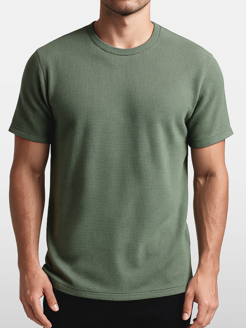 Green knit t-shirt with minimalist O-neck and soft stretch weave — lightweight and breathable design for refined simplicity.