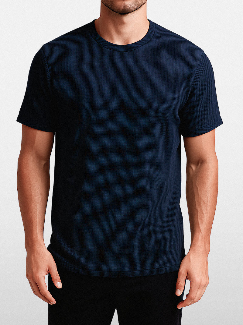 Navy blue short sleeve t-shirt with solid knit texture and clean O-neck — understated fit for quiet everyday elegance.