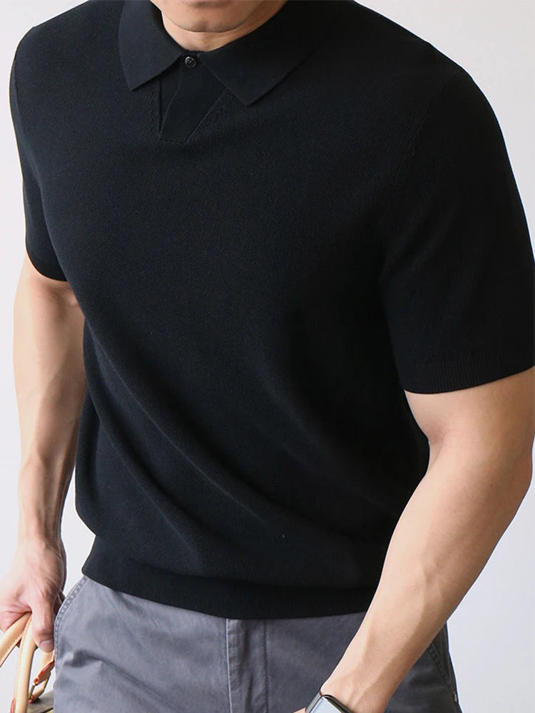 Black knit polo shirt with clean structure and subtle stretch — compact fabric and silent silhouette.