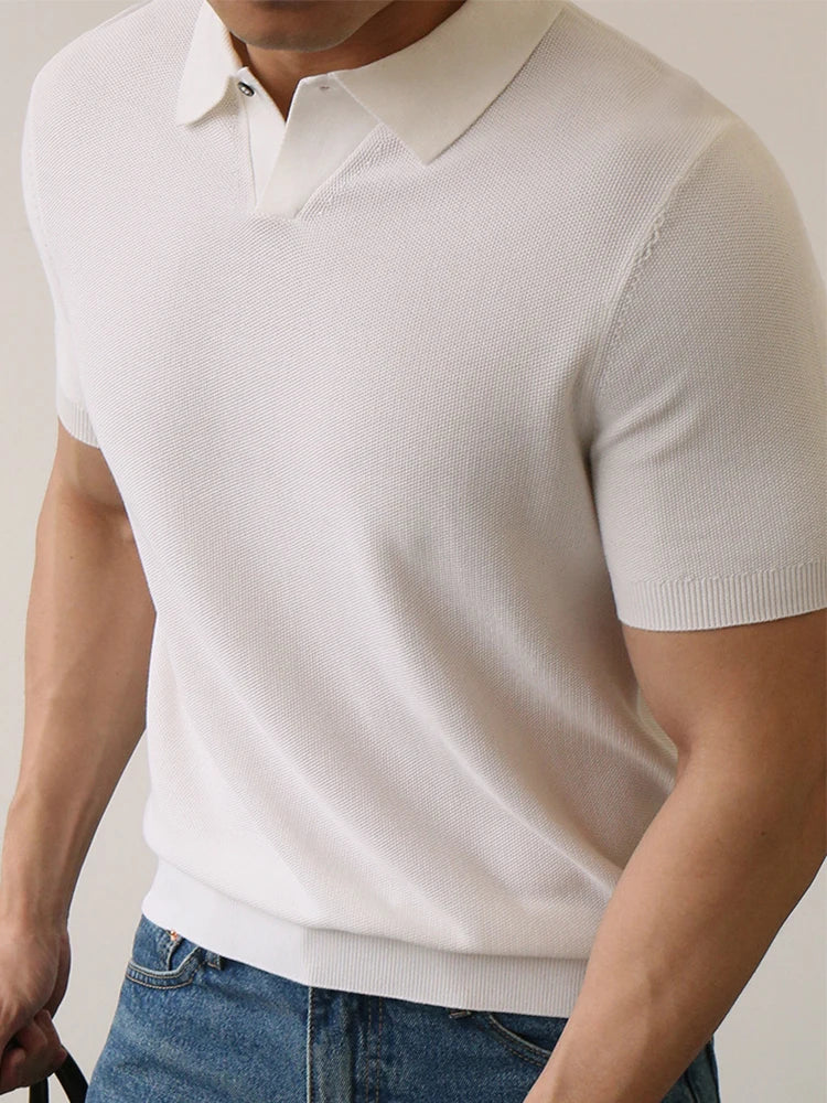 White slim-fit polo shirt with ribbed sleeves and compact knit — lightweight structure with silent presence.